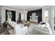 Spacious living room with modern decor, hardwood floors, large windows, and an open layout perfect for entertaining at 2325 Winthrop Ave, Charlotte, NC 28203