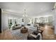 Bright living room with a modern kitchen in the background, hardwood floors, and large sliding doors for indoor-outdoor living at 2325 Winthrop Ave, Charlotte, NC 28203