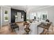Elegant living room featuring stylish decor, hardwood floors, modern chandelier, and ample natural light from large windows at 2325 Winthrop Ave, Charlotte, NC 28203