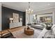 Stylish living room boasting a textured wall, modern lighting, and sliding glass doors to the backyard at 2325 Winthrop Ave, Charlotte, NC 28203