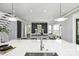Modern kitchen with an island overlooking a beautifully decorated living room with stylish decor at 2325 Winthrop Ave, Charlotte, NC 28203