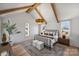 Bright bedroom with vaulted ceilings, exposed beams, and a decorative chandelier, creating a relaxing retreat at 2325 Winthrop Ave, Charlotte, NC 28203