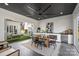 Outdoor dining area with a large fan, adjacent to an outdoor kitchen and fireplace at 2325 Winthrop Ave, Charlotte, NC 28203