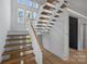Beautiful modern staircase design with light wood treads and white risers, offering a bright and airy feel at 2325 Winthrop Ave, Charlotte, NC 28203