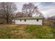 Exterior shot shows backyard with white siding and green metal roof at 2577 Kingston St, Newton, NC 28658
