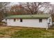 Exterior shot shows backyard with white siding and green metal roof at 2577 Kingston St, Newton, NC 28658