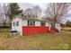 Charming single-story home with red brick foundation, yellow door, and well-maintained lawn at 2577 Kingston St, Newton, NC 28658