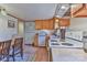 Cozy kitchen features wood cabinets and white appliances, plus dining area at 2577 Kingston St, Newton, NC 28658