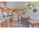 Bright kitchen with wooden cabinets, white appliances, and adjacent dining area at 2577 Kingston St, Newton, NC 28658