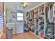 Bright laundry room with washer, dryer, and organized closet shelving for storage at 2577 Kingston St, Newton, NC 28658