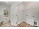 This laundry room includes a utility sink, wire shelving, wood-look floors, and crisp white trim at 2821 New Pineola Rd, Charlotte, NC 28208