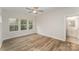 Bright bedroom featuring hardwood floors, ceiling fan, and ensuite bath at 2829 New Pineola Rd # 7B, Charlotte, NC 28208