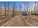 View of the backyard with a shed and a small retaining wall at 2913 Archdale Dr, Charlotte, NC 28210