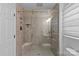 Modern bathroom with glass shower door and tiled walls and floors at 2913 Archdale Dr, Charlotte, NC 28210