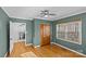 View of a bedroom with gleaming hardwood floors, a modern ceiling fan, and an en suite bathroom at 2913 Archdale Dr, Charlotte, NC 28210