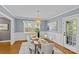 Bright dining room with a modern chandelier, wainscoting detail, and hardwood floors for an elegant touch at 2913 Archdale Dr, Charlotte, NC 28210