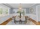 Inviting dining room with a modern chandelier, wainscoting detail, and hardwood floors for a classic touch at 2913 Archdale Dr, Charlotte, NC 28210