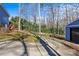Long driveway leading to a shed and house, surrounded by trees and nature at 2913 Archdale Dr, Charlotte, NC 28210