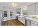 Updated kitchen featuring stainless steel appliances, gray cabinets, quartz countertops, and a view to the backyard at 2913 Archdale Dr, Charlotte, NC 28210