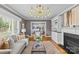 Well-appointed living room featuring a fireplace, hardwood floors, neutral decor, and an open view to the dining area at 2913 Archdale Dr, Charlotte, NC 28210