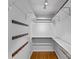 Walk-in closet with custom shelving and hardwood floors at 2913 Archdale Dr, Charlotte, NC 28210