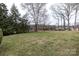 View of the backyard with mature trees and lake view at 404 Downing Dr, Kings Mountain, NC 28086