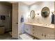 Double sink bathroom vanity with marble countertops and vintage-style lighting at 404 Downing Dr, Kings Mountain, NC 28086