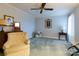 Light blue bedroom with vintage accents, including lamps, portraits, and a comfortable chair at 404 Downing Dr, Kings Mountain, NC 28086