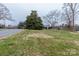 Well-maintained front lawn of a cozy home with mature trees at 404 Downing Dr, Kings Mountain, NC 28086