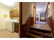 Hallway with stairs leading to an open area next to a laundry room with a washer and dryer at 404 Downing Dr, Kings Mountain, NC 28086