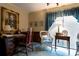 Cozy home office with a desk, wicker chair, and vintage décor, bathed in natural light at 404 Downing Dr, Kings Mountain, NC 28086