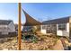 Backyard showcasing a shade sail over a koi pond, a rock path, and a shed with black metal roof at 417 Galesburg Dr, Monroe, NC 28110