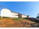 View of the home's backyard featuring a sloped yard, partial grass, shed, and shade sail at 417 Galesburg Dr, Monroe, NC 28110