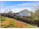 The spacious backyard with partial grass features a utility shed and a wooden fence at 417 Galesburg Dr, Monroe, NC 28110