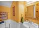 Cozy half bath with cream walls, a pedestal sink, and decorative accents at 417 Galesburg Dr, Monroe, NC 28110