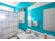 Bright bathroom with blue walls, a vanity, and shower with themed curtains at 417 Galesburg Dr, Monroe, NC 28110