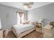 Bedroom with gray walls, decorated with curtains and decor around the window at 417 Galesburg Dr, Monroe, NC 28110