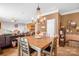 Open dining area with access to the living room, featuring a wooden table and decorative accents at 417 Galesburg Dr, Monroe, NC 28110