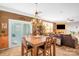 Bright dining area with a wooden table, sliding glass doors, and an elegant light fixture at 417 Galesburg Dr, Monroe, NC 28110
