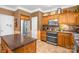 Well-equipped kitchen with wooden cabinets, stainless steel appliances, and a granite countertop at 417 Galesburg Dr, Monroe, NC 28110