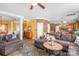 Open-concept living space with a large sofa, hardwood floors, and a decorative area rug at 417 Galesburg Dr, Monroe, NC 28110