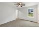 Bedroom with a ceiling fan, neutral carpet, a window, and a closet at 419 N Caldwell St # 1, Salisbury, NC 28144