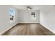 Spacious bedroom showcasing wood-look floors, neutral walls, two bright windows, and a modern ceiling fan at 419 N Caldwell St # 1, Salisbury, NC 28144