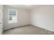 Bedroom with neutral carpet, a large window, and neutral walls at 419 N Caldwell St # 1, Salisbury, NC 28144