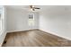 Bright bedroom with neutral walls, wood-look floors, a modern ceiling fan, and a window with outside views at 419 N Caldwell St # 1, Salisbury, NC 28144