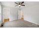 Bedroom features neutral carpet, a ceiling fan, and two closets at 419 N Caldwell St # 1, Salisbury, NC 28144
