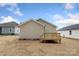 View of the home's back exterior and backyard with small deck at 419 N Caldwell St # 1, Salisbury, NC 28144
