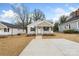 Charming single-story home featuring neutral siding, a welcoming front porch, and a well-manicured lawn at 419 N Caldwell St # 1, Salisbury, NC 28144
