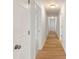 Hallway featuring light wood flooring, white doors, and neutral wall paint at 419 N Caldwell St # 1, Salisbury, NC 28144