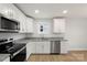 Well-lit kitchen featuring stainless steel appliances, light wood flooring, and granite countertops at 419 N Caldwell St # 1, Salisbury, NC 28144